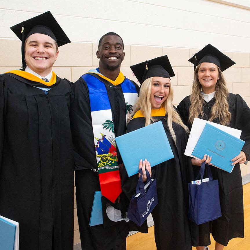 负担得起的伊玛库拉塔大学学位——四个毕业后微笑的学生